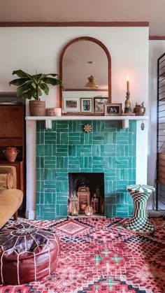 a living room filled with furniture and a fire place in front of a green tiled fireplace