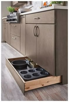 an open drawer in the middle of a kitchen