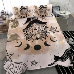 a bed covered in a black and white cover with an image of a witch on it