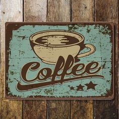 a sign that says coffee with a cup in it on a wooden wall next to wood planks