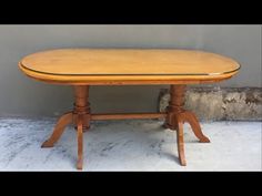 an oval wooden table with four legs