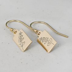 "These Lavender Stem Earrings bring a subtle botanical touch to your style with petite tags in either gold filled or sterling silver. Choose from classic french hook or lever back earwires for a perfect fit. A great gift for young adults or for stacking with multiple earrings, these dainty, minimalist designs bring a touch of nature to your look. *Handcrafted from sheet metal - 6x12mm Rectangular Tag *Approximate Drop Length: 1 to 1 1/8\" depending on choice of ear wire *Satin finish 14/20 Gold Filled or .925 Sterling Silver *Boxed in simple kraft cotton filled box with ribbon bow *Polishing cloth included with all orders *Handmade when ordered prior to shipping, please see storefront for production times Stamped personalization on gold-filled or sterling silver with punch and hammer. Slig Nature, Stem Earrings, Multiple Earrings, Minimalist Designs, Botanical Design, Silver Box, Ribbon Bow, Sheet Metal, Etsy Shipping