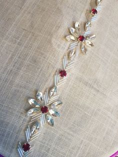 a close up of a piece of cloth with beads and jewels on it's side