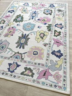 a white rug with colorful flowers on it