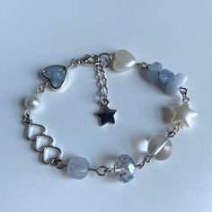 a bracelet with hearts, stars and pearls