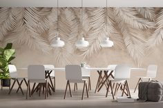 a dining room table with white chairs and palm leaves on the wall in front of it