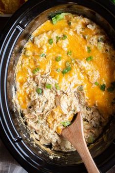 a crock pot filled with chicken and rice