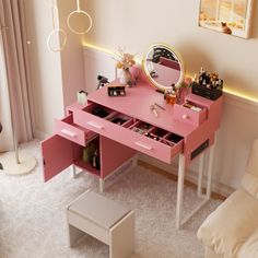 a pink vanity table with drawers and mirror in a living room next to a white couch