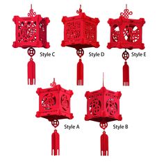 four different styles of red chinese lanterns hanging from hooks and chains, each with an intricate design on the front