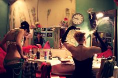 two women in bathing suits are doing hair and make - up at a vanity table