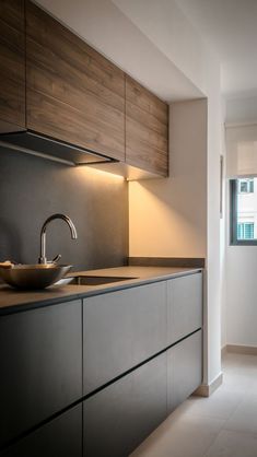 a modern kitchen with stainless steel appliances and wooden cabinets