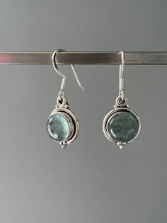 Sterling silver aquamarine dangle earrings . Beautiful Aquamarine stones set in sterling silver. All stones are natural and therefore each one is unique. Aquamarine is a healing stone, a stone of courage used for reducing stress and calming the mind. Promotes self expression and increases sensitivity and highly protective during pregnancy. Boosts the immune system and a great meditation stone. Birthstone of March. Gift box available for purchase. Search GIFTBOX Silver Aquamarine Dangle Earrings, Silver Aquamarine Gemstone Earrings, Silver Aquamarine Jewelry Set With Earrings, Handmade Blue Topaz Dangle Earrings, Handmade Aquamarine Dangle Earrings, Silver Aquamarine Round Earrings, Aquamarine Matching Earrings Jewelry, Aquamarine Round Jewelry With Matching Earrings, Silver Green Amethyst Earrings For Gift