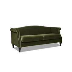 a green velvet sofa with studded arms