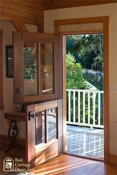 an open door leading to a deck with a view of trees and water in the distance