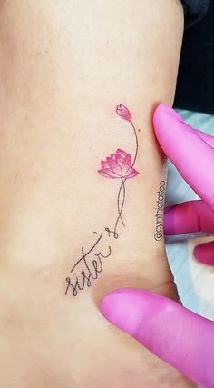 a woman's foot with a flower tattoo on her left ankle and the word sister written in cursive writing