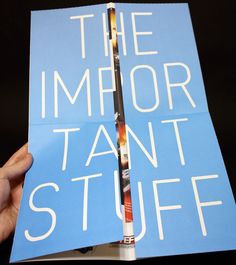 a person holding up a book with the words the mirror tant stuff on it