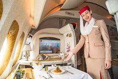 a woman is serving food on an airplane