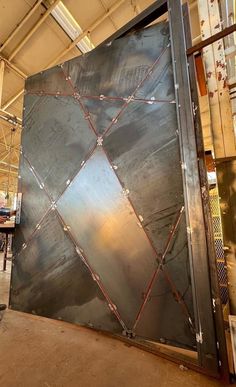 a large metal door is being worked on