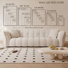 a living room with white furniture and wall art size guide on the walls above it