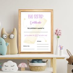 a big sister certificate is displayed on a shelf next to stuffed animals and other toys