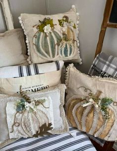 four pillows with decorative pumpkins on them