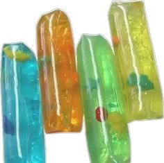 four different colored plastic tubes are in the shape of fish tails and one is yellow, green, blue, and orange