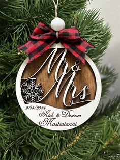 a wooden ornament hanging from a christmas tree with the word mr and mrs on it