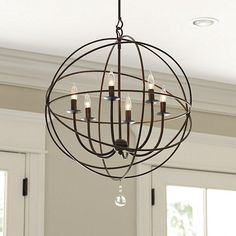 a chandelier with candles hanging from it's center and the words, orb 6 - light from ballard designs garrett is making something similar to