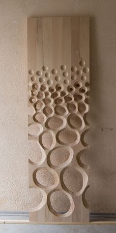 a sculpture made out of wood with circles on it