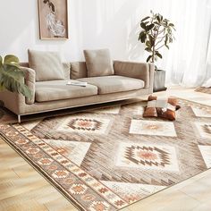 a living room with a couch, rug and potted plant