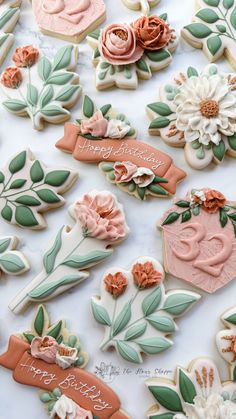 decorated cookies with flowers and leaves on a table