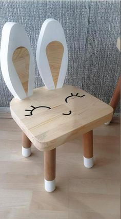 two wooden chairs with faces drawn on them