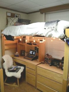 a loft bed with desk underneath it and lights on the bottom bunk beds are lit up