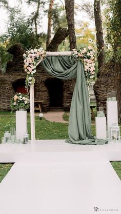 an outdoor ceremony setup with flowers and candles