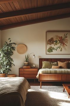 a bed sitting in a bedroom next to a wooden dresser and table with a potted plant on top of it