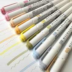 six markers are lined up on a table with the words mildliners written in them