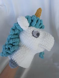 a crocheted stuffed animal with a horn on it's head is shown