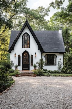 a white and black house surrounded by trees