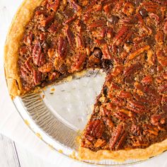 a pecan pie with one slice missing from it