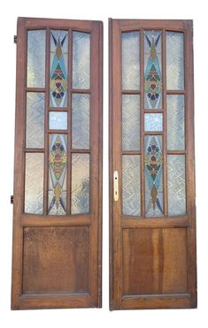 two wooden doors with stained glass panels