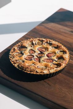 a pie sitting on top of a wooden cutting board