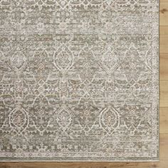 a large rug with an intricate design on the top and bottom, in grey tones