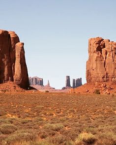 two large rocks in the middle of a desert