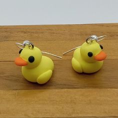 two yellow rubber ducks sitting on top of a wooden table