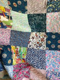 a patchwork quilt with many different colors and patterns