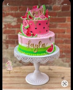 a pink and green cake with watermelon on top