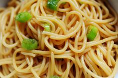 noodles with green onions in a white bowl