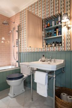 a bathroom with a toilet, sink and bathtub