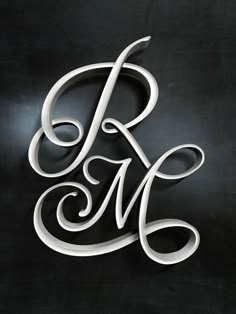 the letter r is made out of white paper and has swirly lines on it