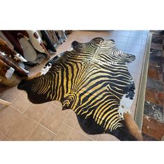 a zebra skin rug is laying on the floor